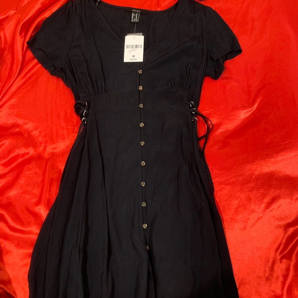 Brand new mini dress with lace up sides!